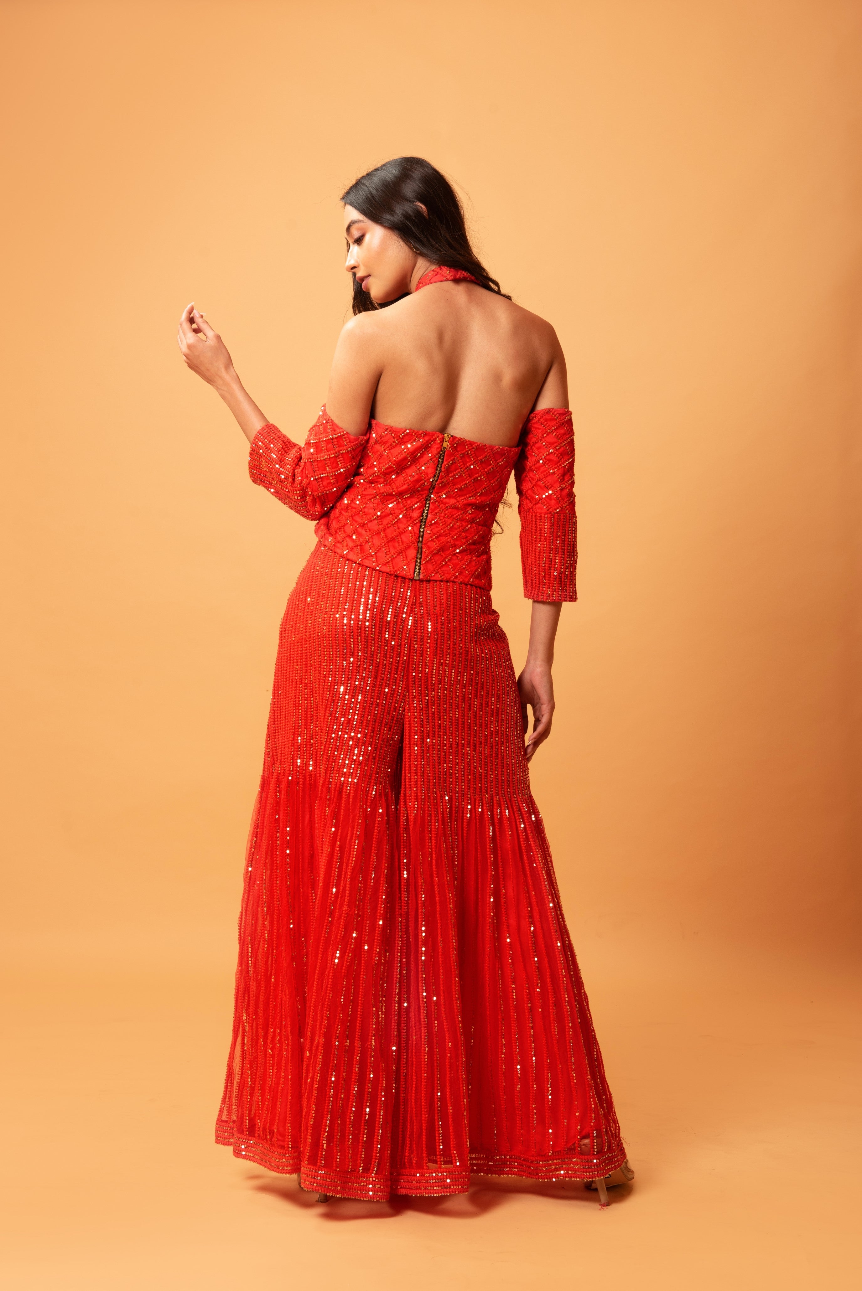 Red sequined tulle sharara set with a halterneck off-shoulder top.