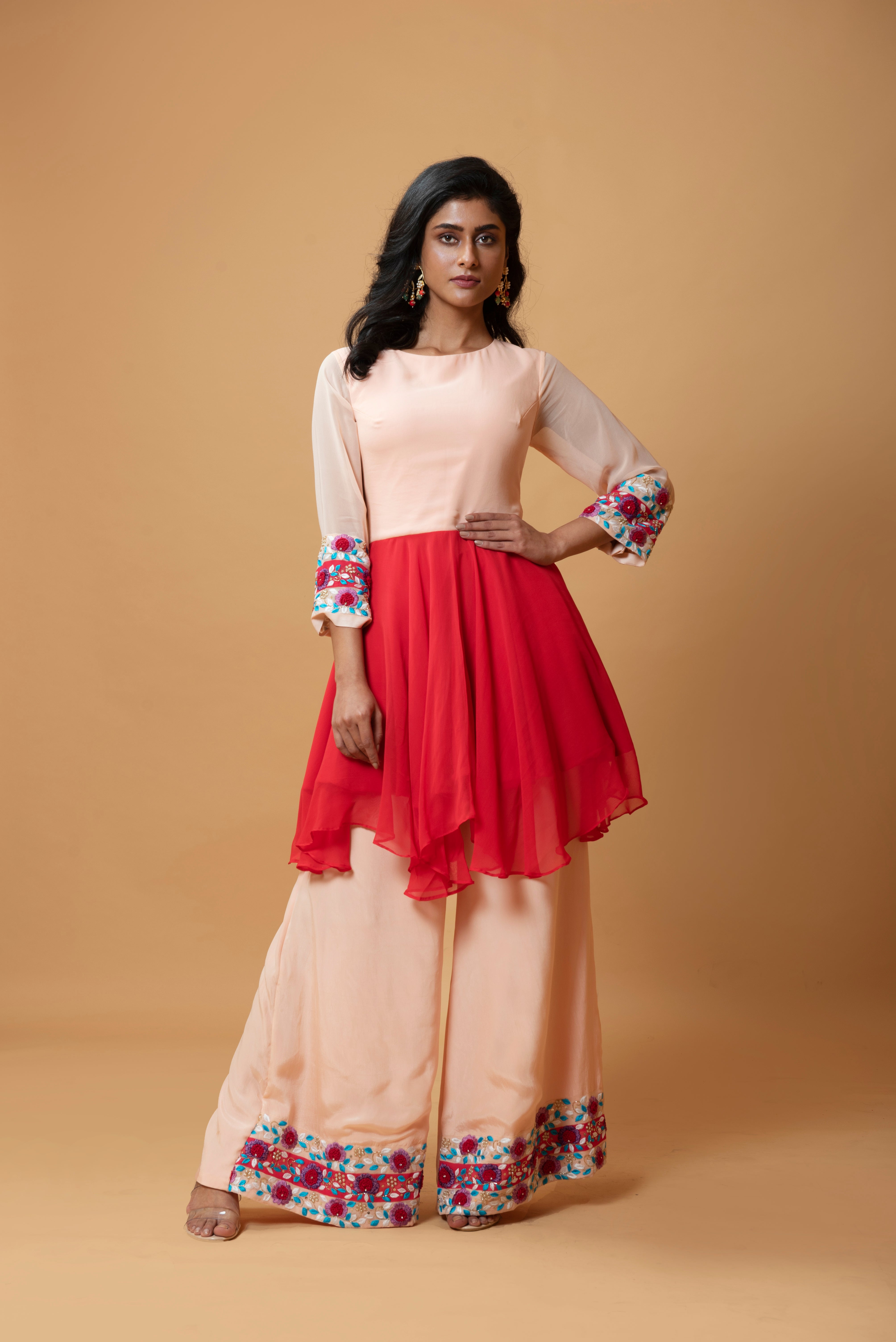 Red double-shaded sharara set with intricate floral hand embroidery.