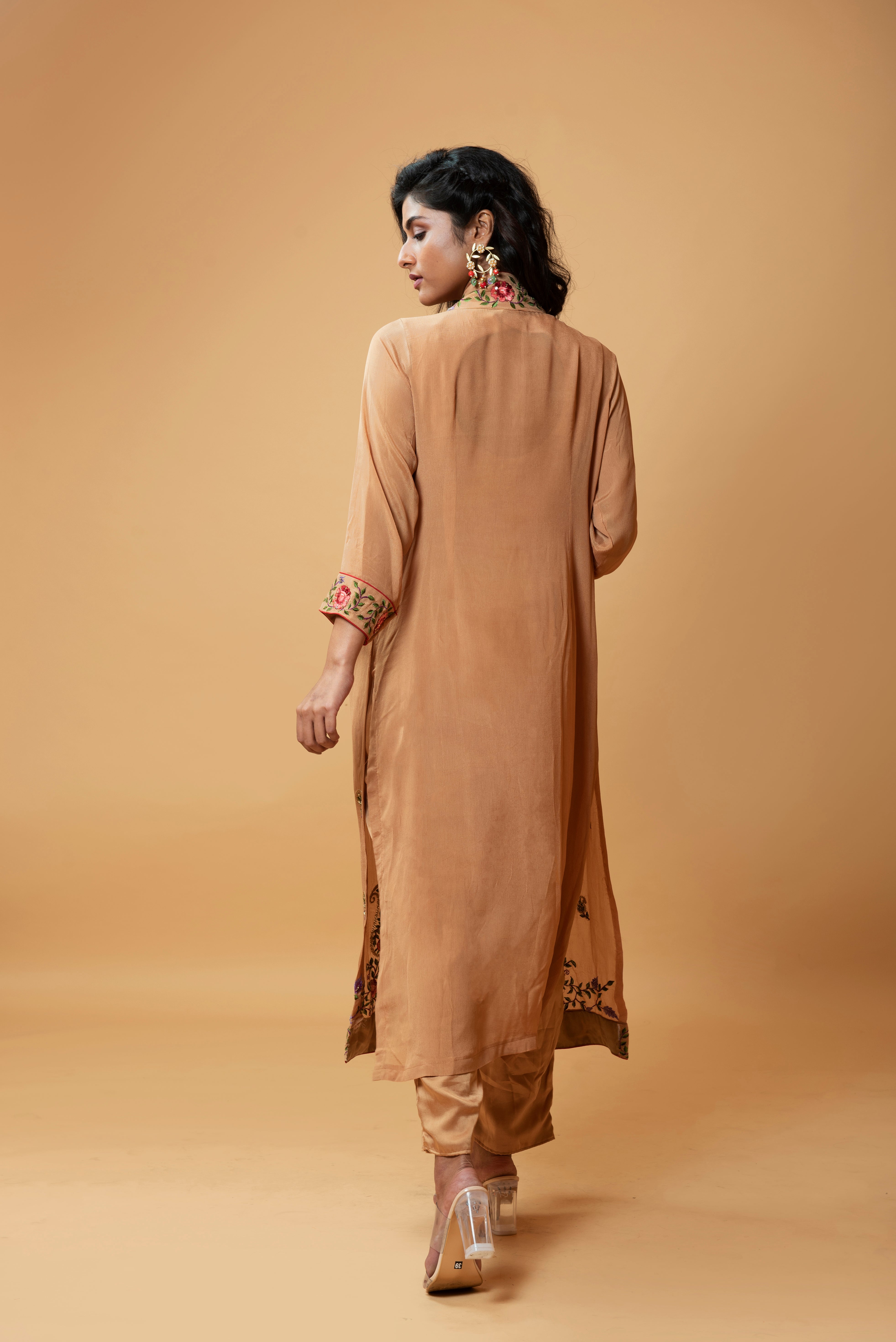 Light bronze jumpsuit with an embroidered jacket featuring floral motifs.