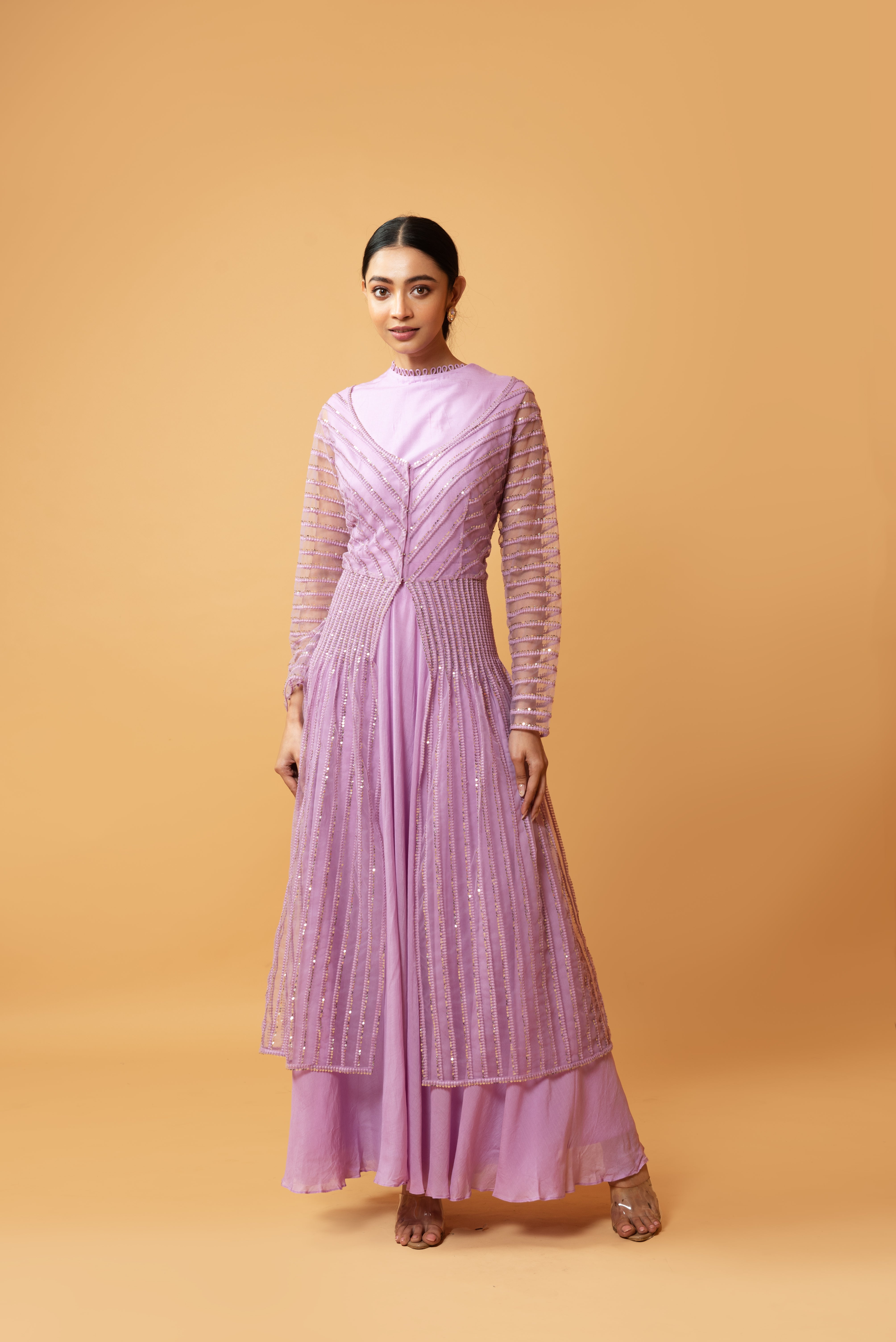 Lilac muslin gown with a sequined full-sleeved jacket.