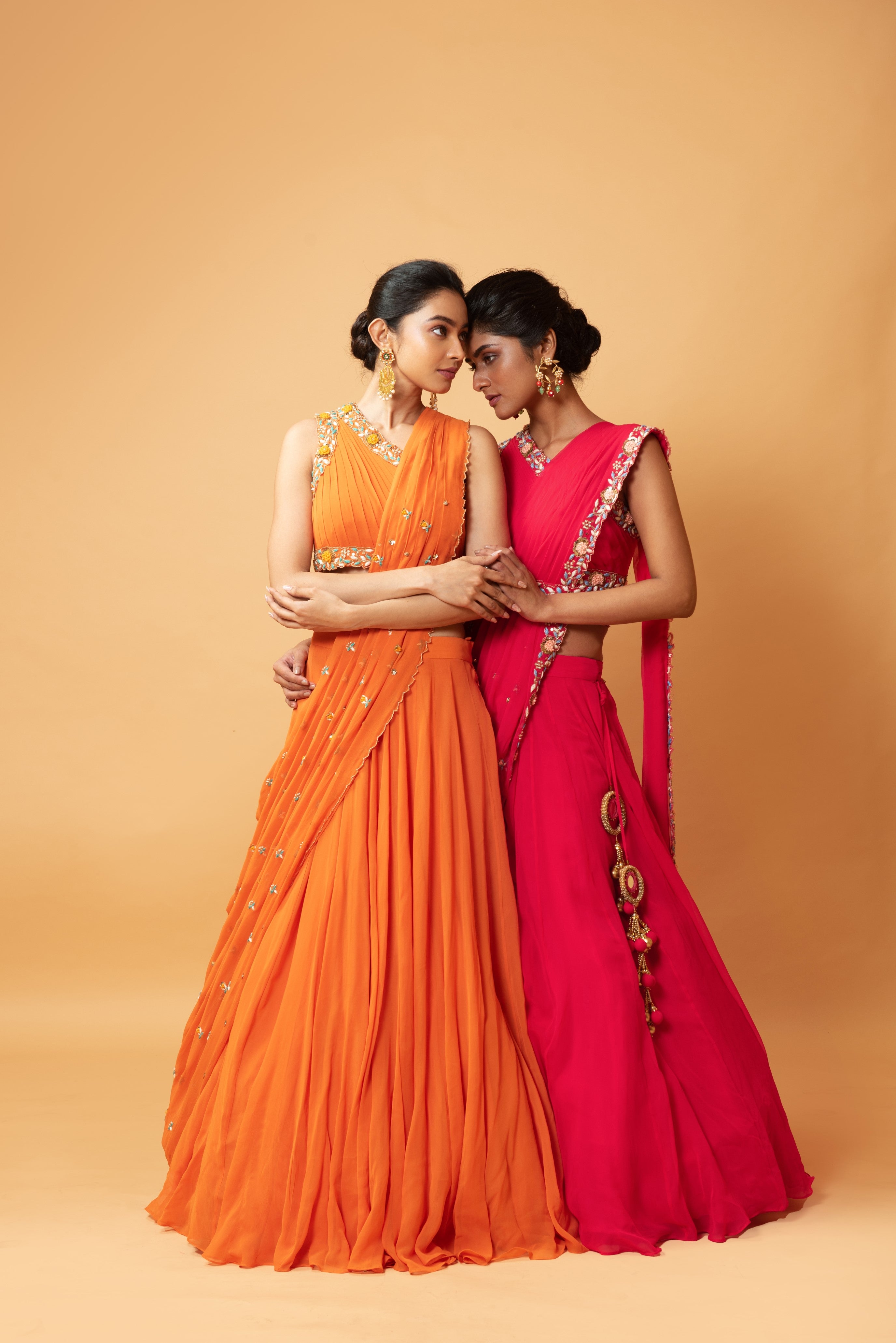 Fuschia pink draped lehenga with hand-embroidered waist belt.