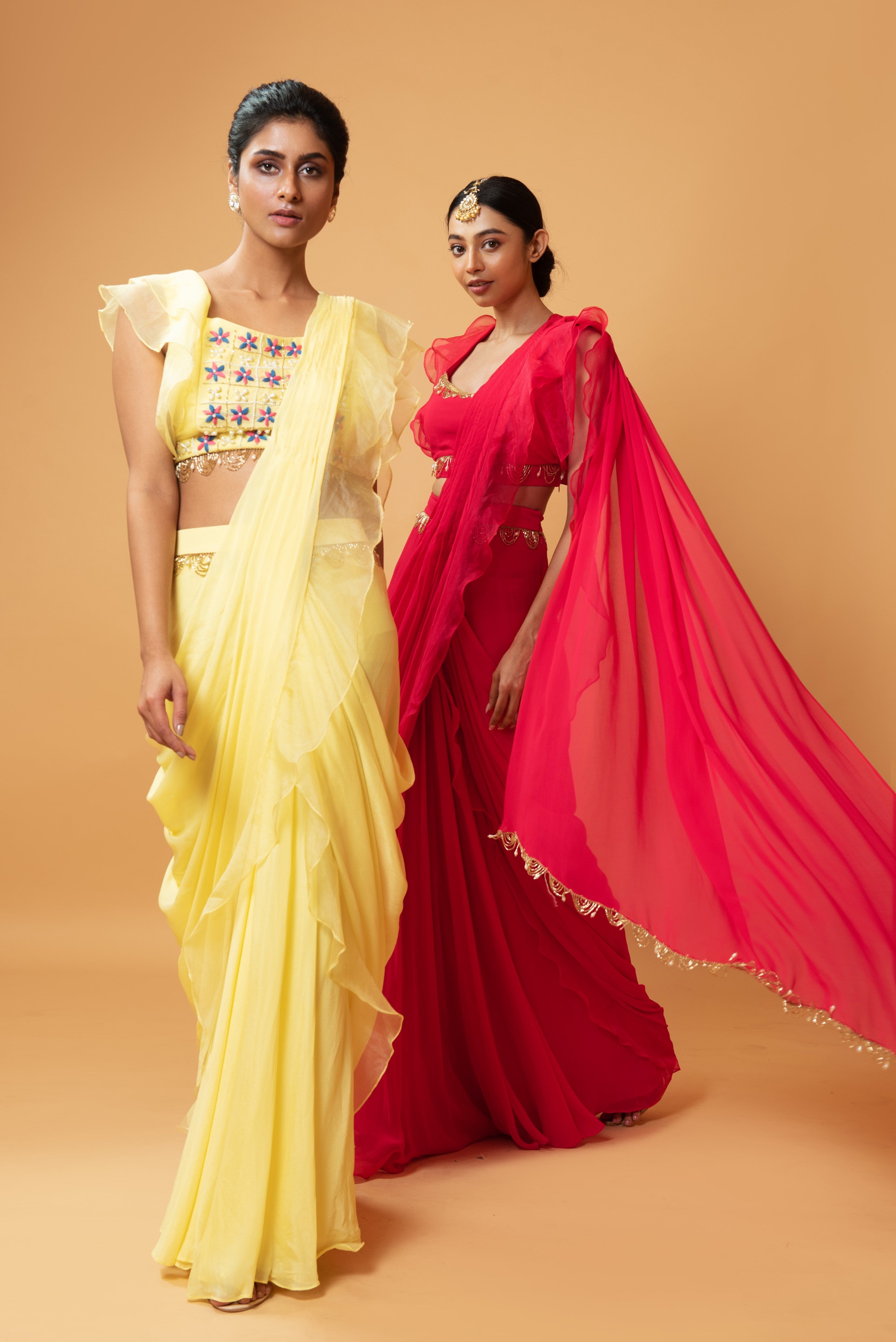 Fuschia pink ruffle saree with lace detailing on neckline and waist.