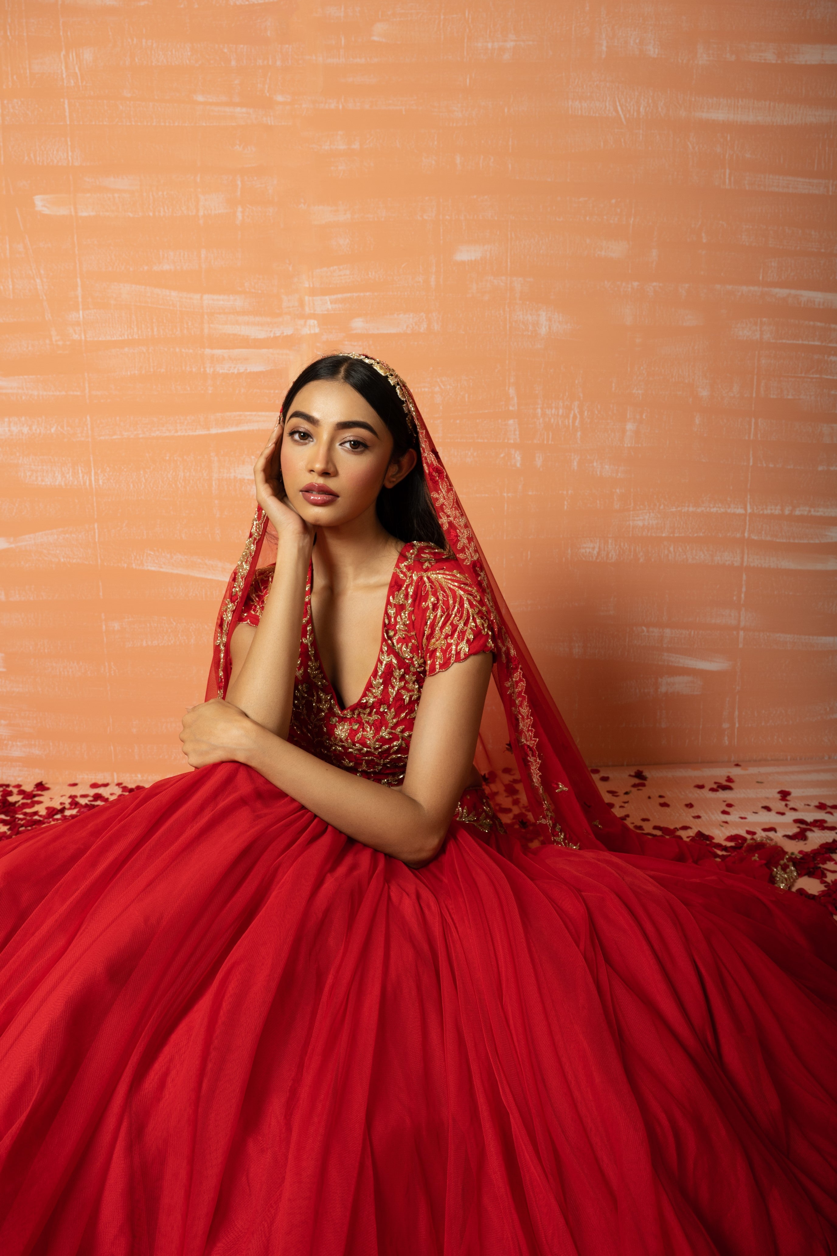 Red soft net lehenga with intricate hand embroidery for an ethereal look.