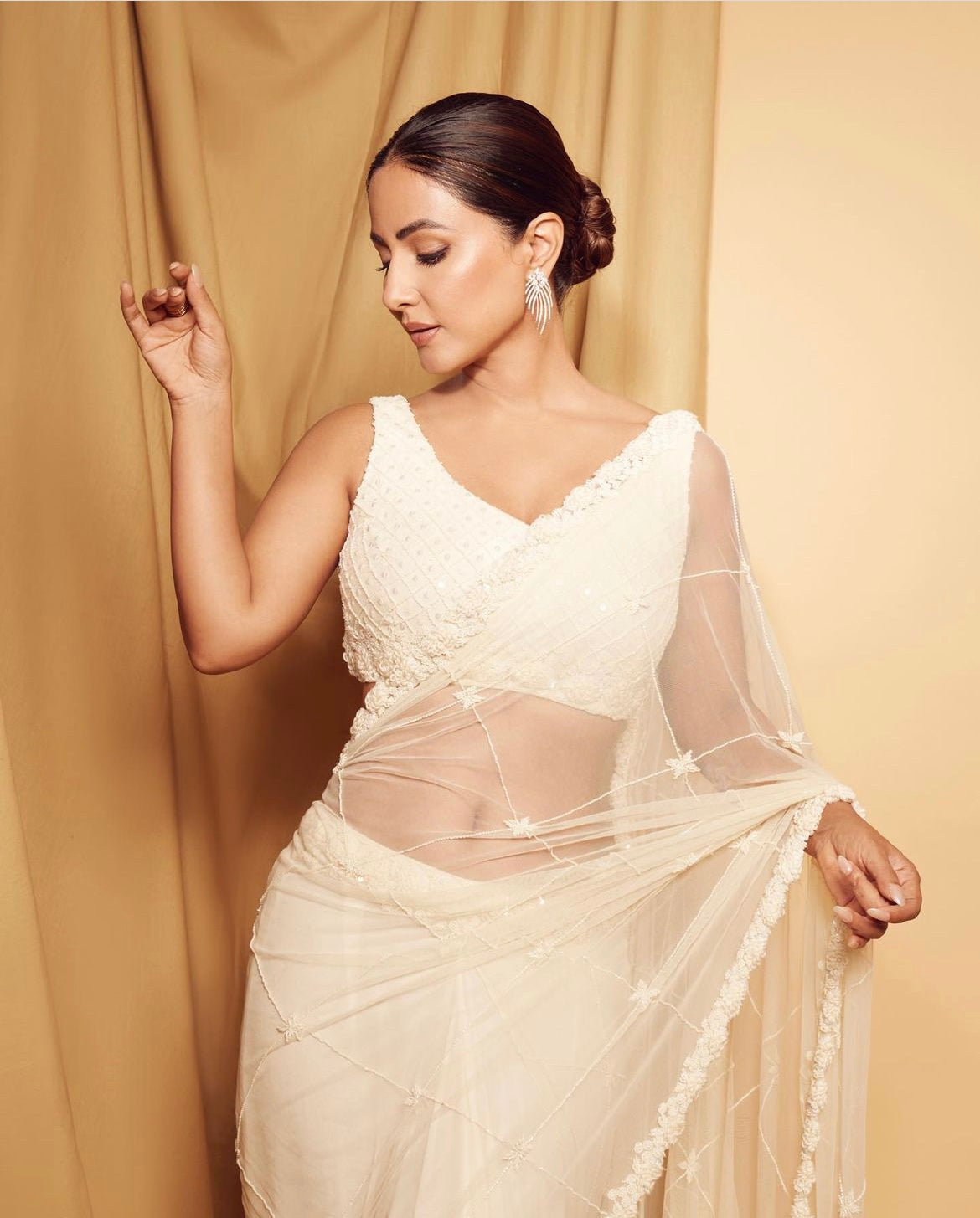 Hina Khan wearing an ivory pre-stitched saree with hand embroidery.