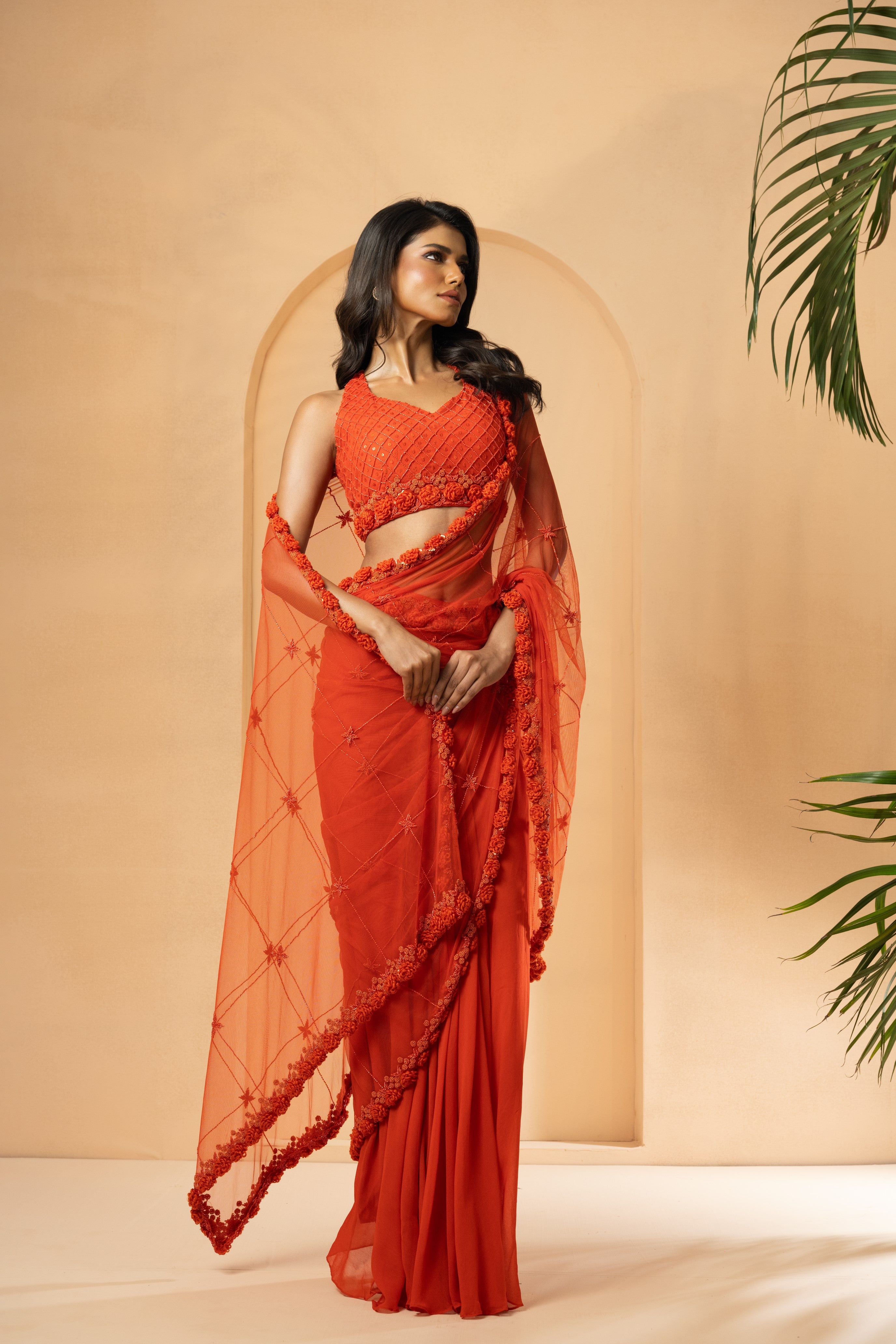Orange pre-stitched drape saree with self-on-self embroidery in georgette and net.