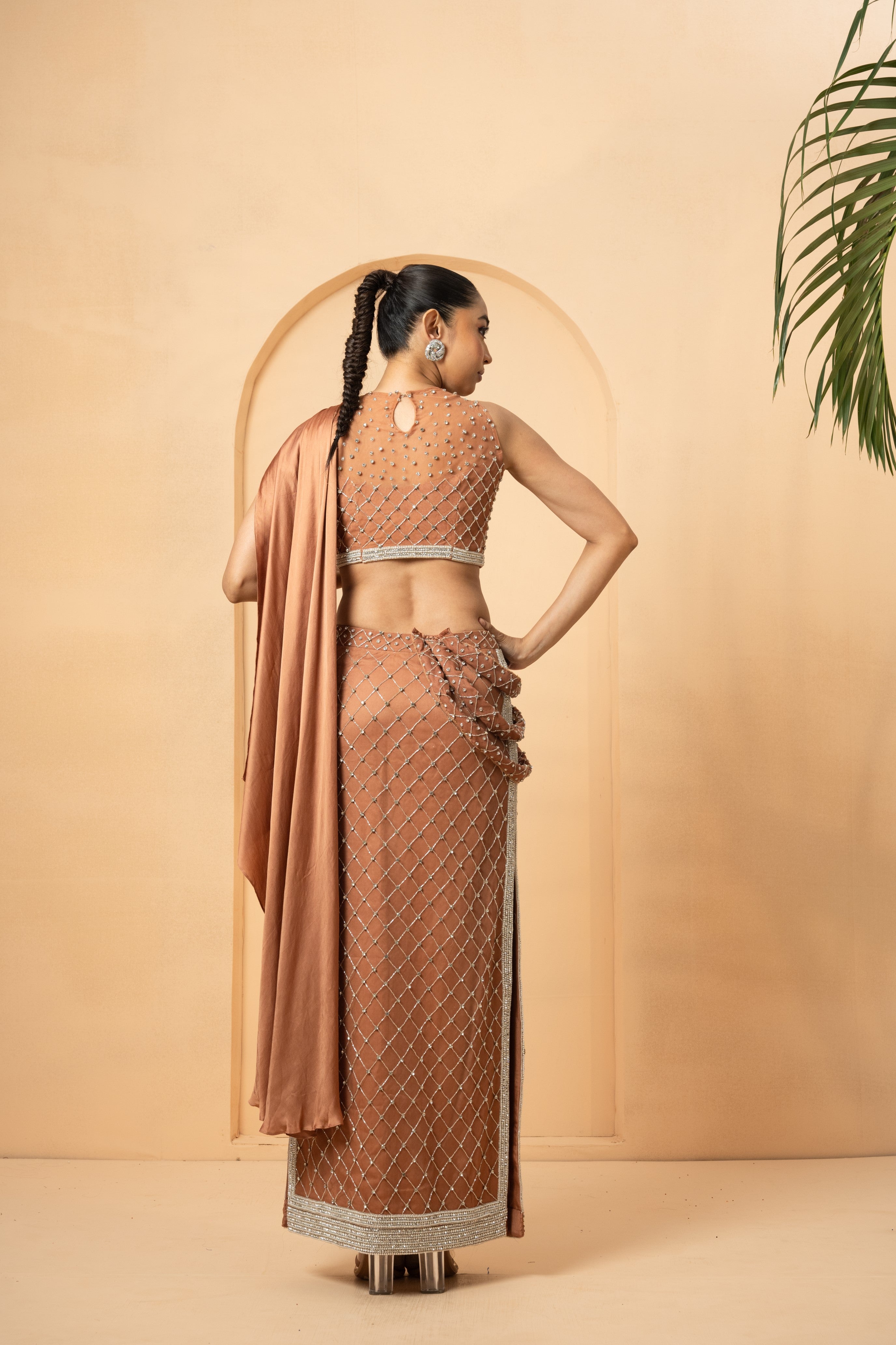 Beige saree with twisted drape dupatta and intricate hand embroidery.