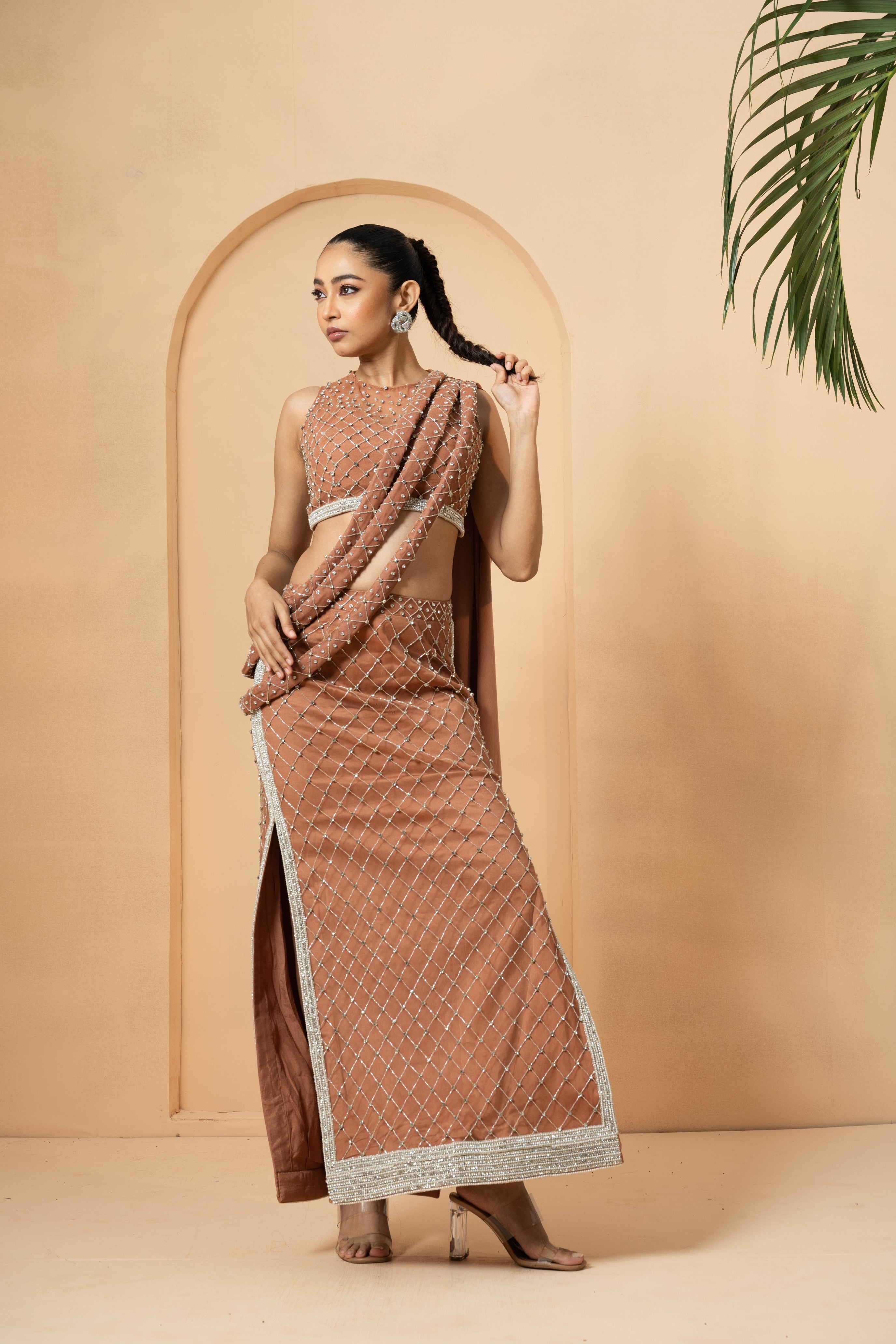 Beige saree with twisted drape dupatta and intricate hand embroidery.