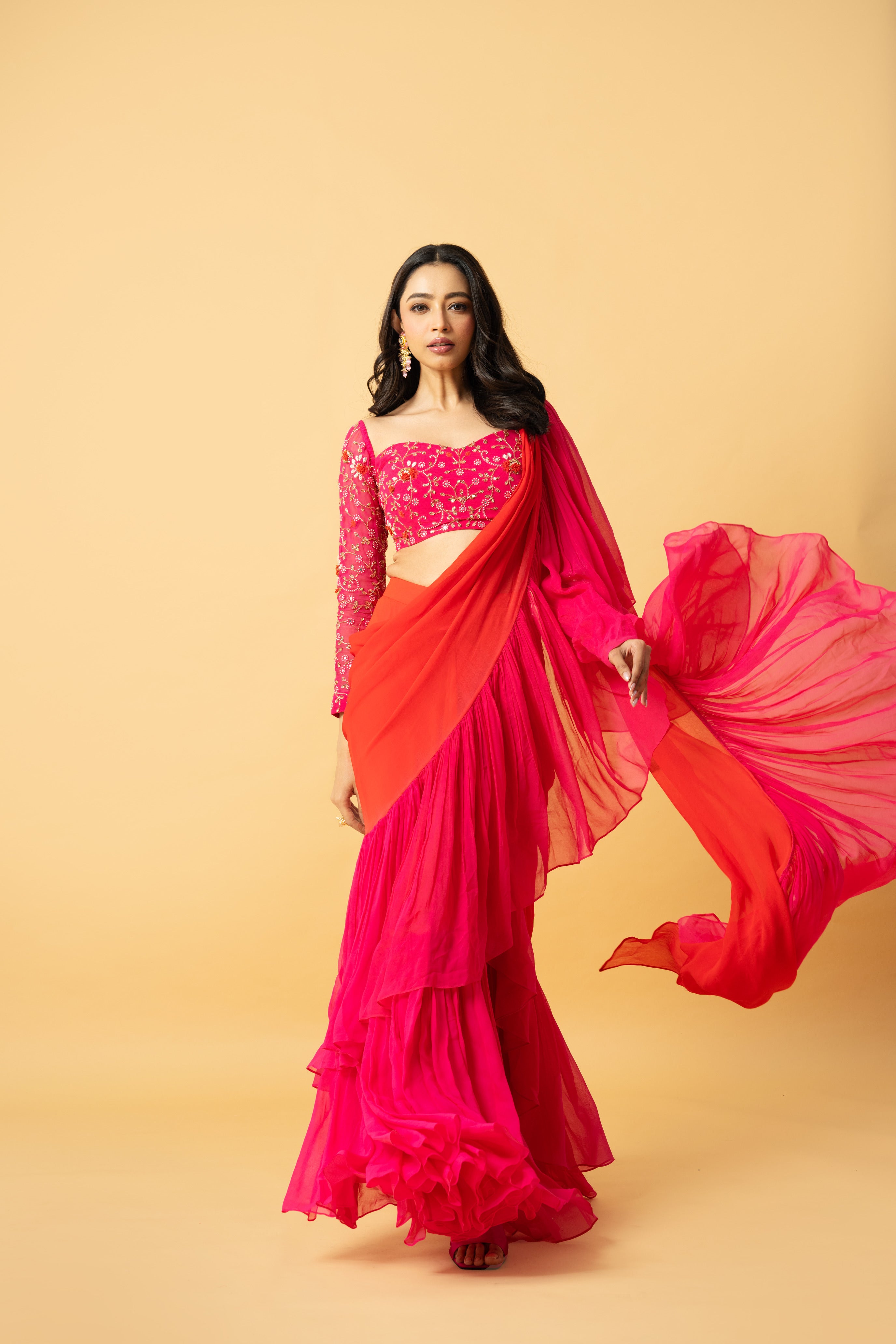 Pink and orange georgette ruffle saree with hand-embroidered full-sleeve blouse.