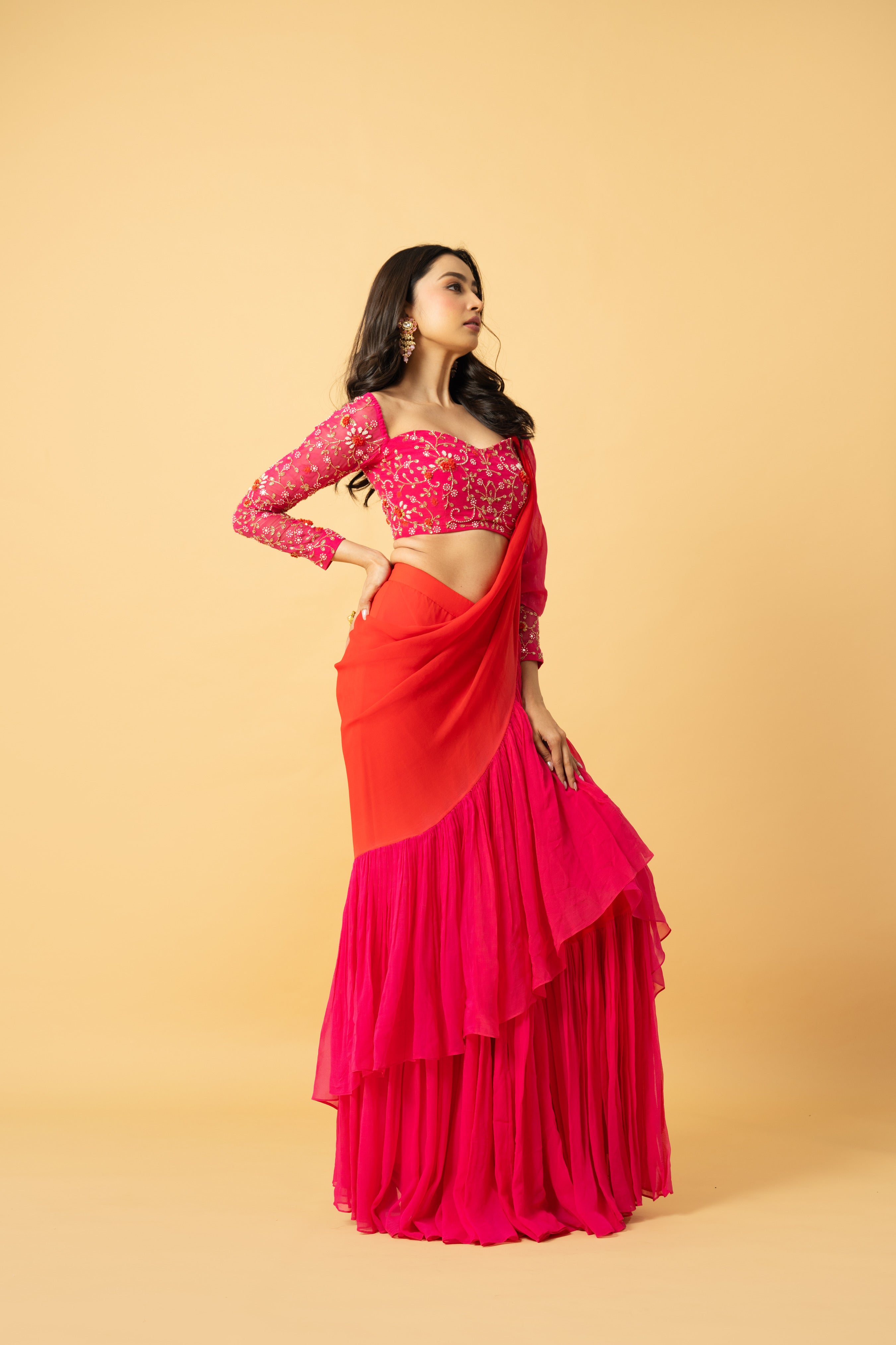 Pink and orange georgette ruffle saree with hand-embroidered full-sleeve blouse.