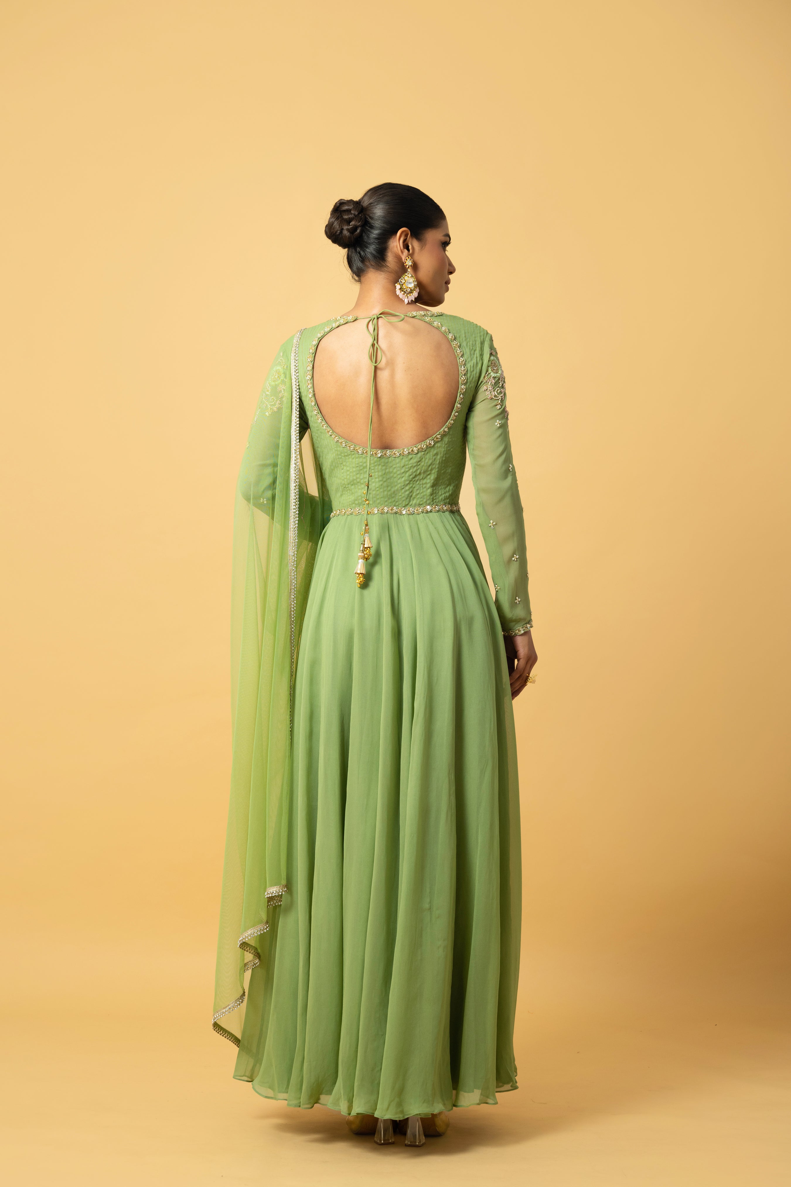 Mint green georgette Anarkali with intricate embroidery and soft net dupatta.