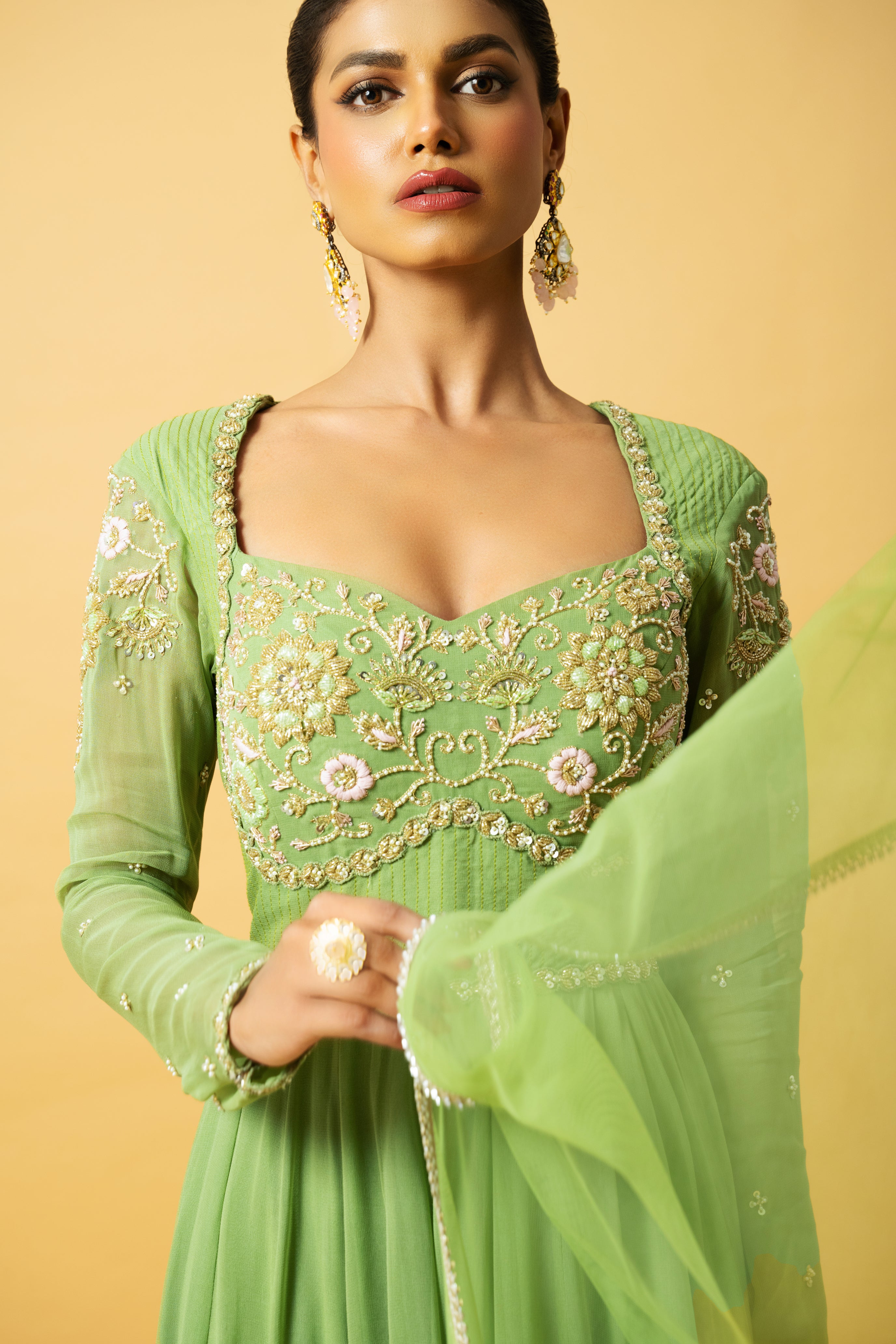 Mint green georgette Anarkali with intricate embroidery and soft net dupatta.
