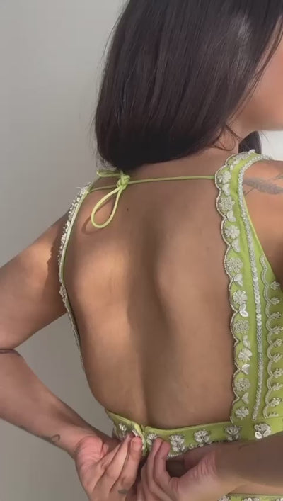 Lime green lehenga with embroidered blouse, belt, and choker dupatta.